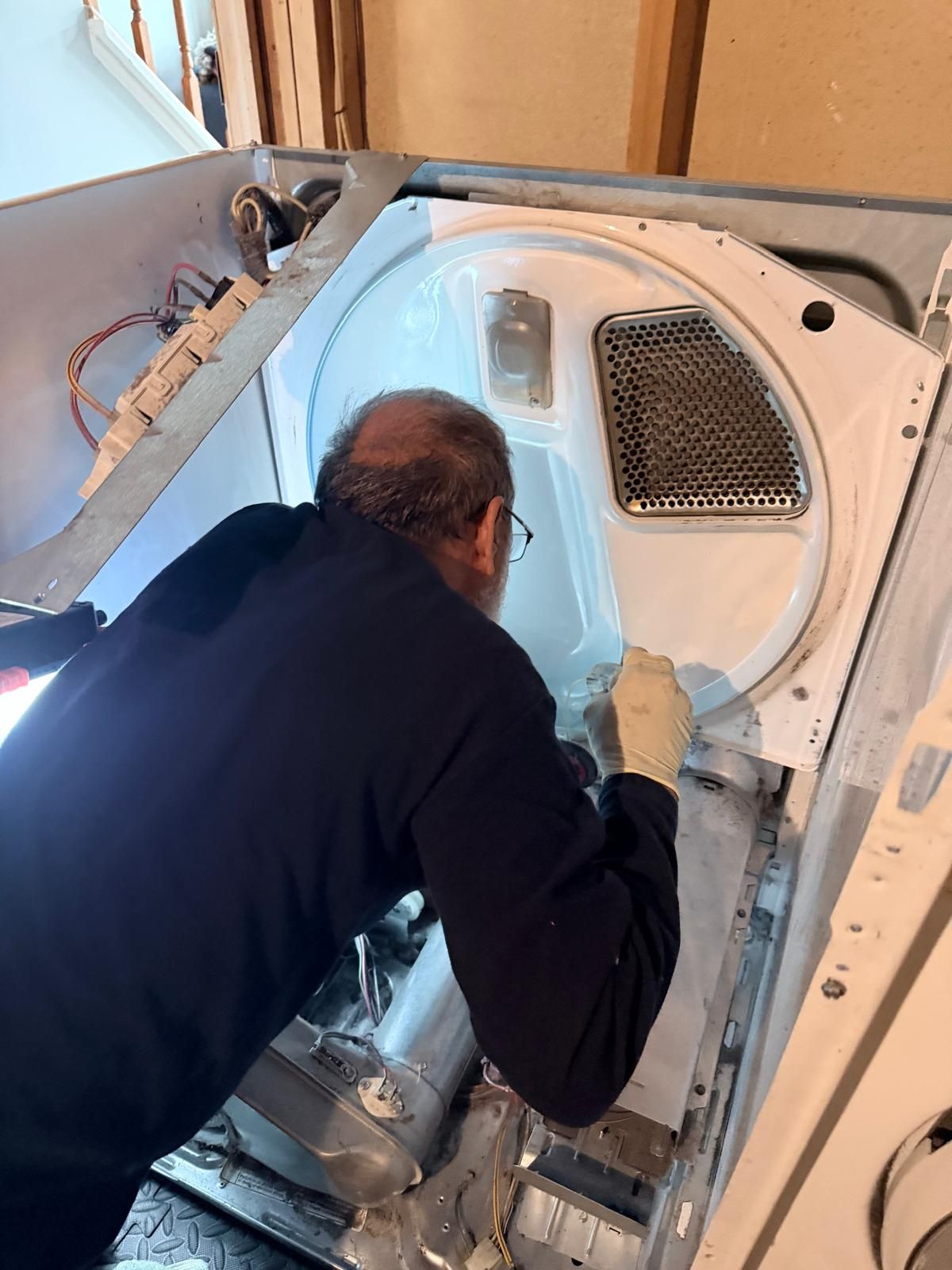 OnSpot technician repairing a dryer drum