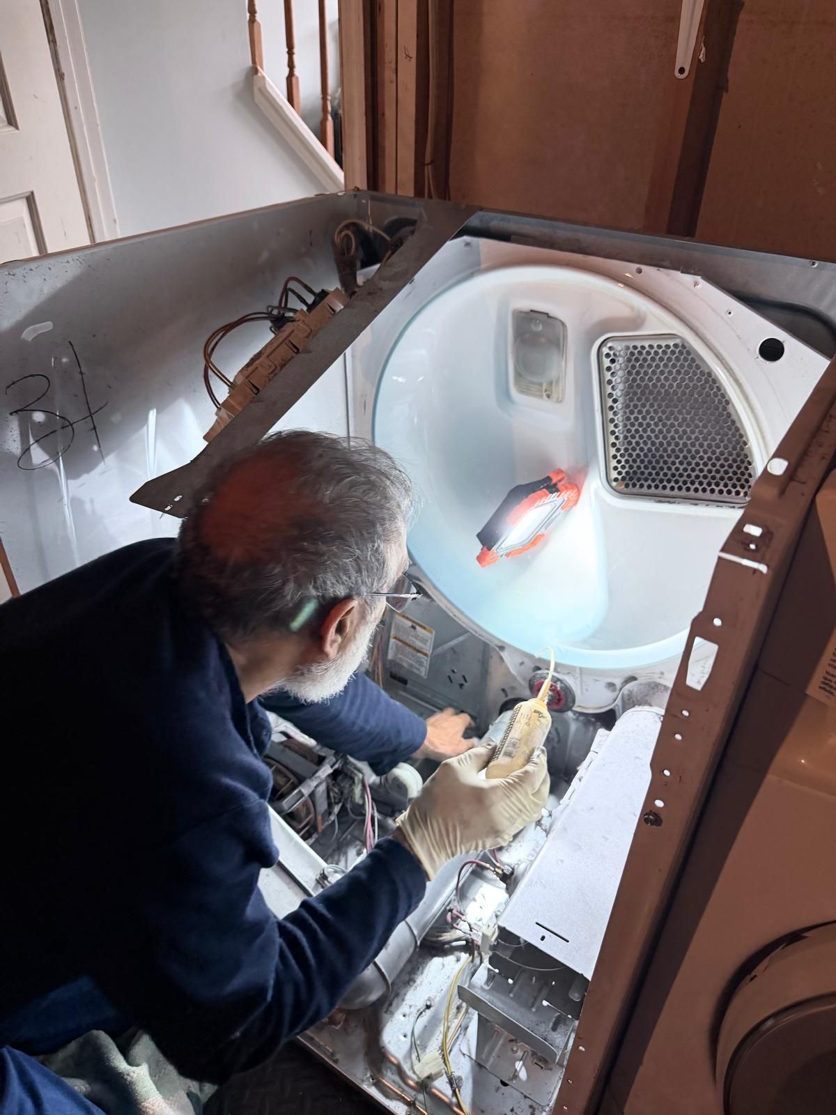 OnSpot technician working inside a dryer cabinet