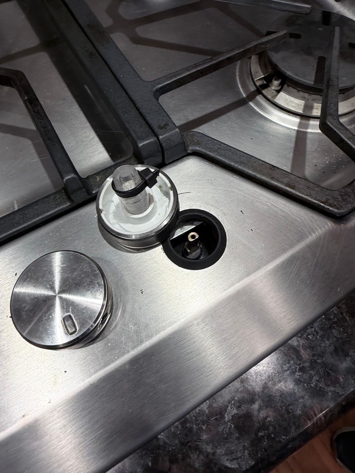 Gas cooktop burner igniter with the cap removed